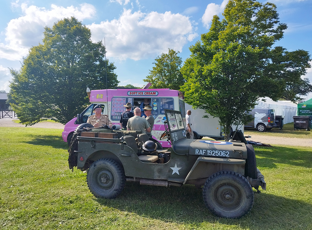 Fat Sam's pink ice cream van at a festival, photographed with a Willys jeep