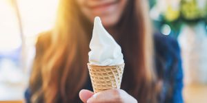 young girl with a soft-serve whippy ice cream in a cone in her hand